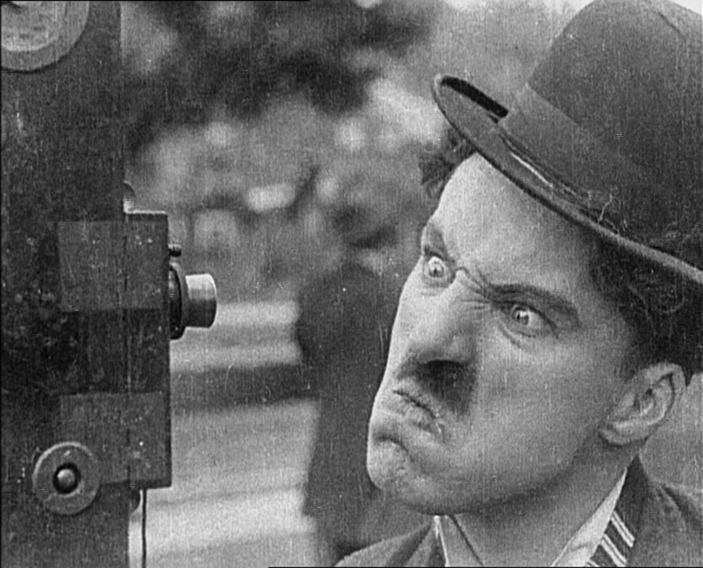Charlie Chaplin "Hello world!" Charlie Chaplin mugs for the camera in Keystone's Kid Auto Races at Venice (1914), the Little Tramp's first public outing.