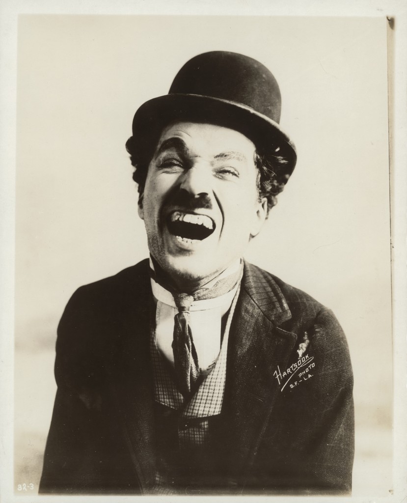 Charlie Chaplin laughing during his time with Mutual Films, circa 1916, by Fred Hartsook