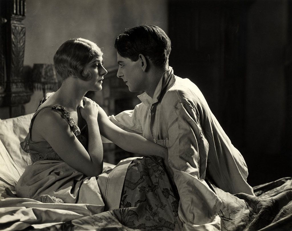 Isabel Jeans and Robin Irvine on a bed in Easy Virtue (1927, dir. Alfred Hitchcock)